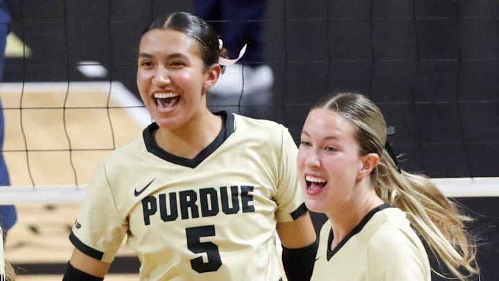 Purdue Boilermakers Setter Taylor Anderson (5) and outside hitter Kenna Wollard (4) celebrate 