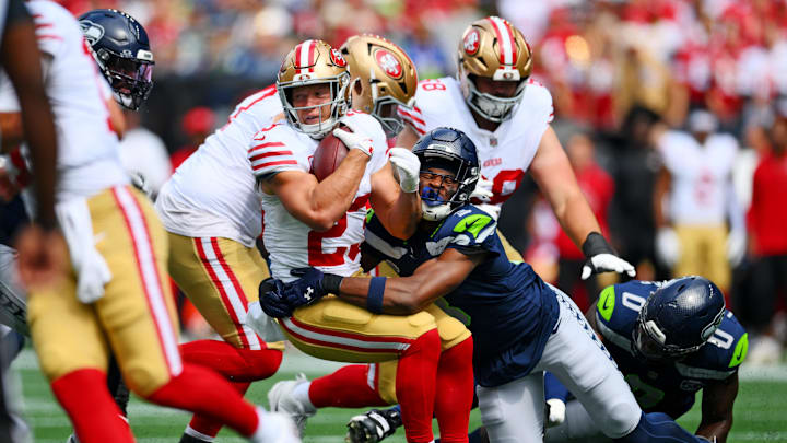 Sep 7, 2025; Seattle, Washington, USA; Seattle Seahawks safety Nick Emmanwori (3) tackles San Francisco 49ers running back Christian McCaffrey (23) during the first half at Lumen Field. Mandatory Credit: Steven Bisig-Imagn Images