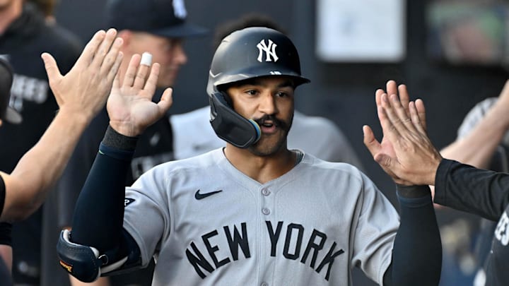 Aug 20, 2025; St. Petersburg, Florida, USA; New York Yankees center fielder Trent Grisham (12) celebrates in the dugout after hitting a solo home run in the first inning against the Tampa Bay Rays  at George M. Steinbrenner Field. Mandatory Credit: Jonathan Dyer-Imagn Images