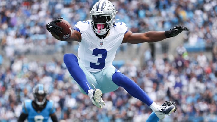 Dallas Cowboys wide receiver George Pickens jumps over a defender against the Carolina Panthers.