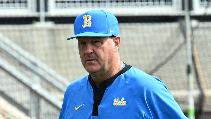 Jun 17, 2025; Omaha, Neb, USA; UCLA Bruins head coach John Savage (22) walks to the dugout before the restart of the game against the LSU Tigers at Charles Schwab Field. Mandatory Credit: Steven Branscombe-Imagn Images Jun 17, 2025; Omaha, Neb, USA; UCLA Bruins head coach John Savage (22) walks to the dugout before the restart of the game against the LSU Tigers at Charles Schwab Field. Mandatory Credit: Steven Branscombe-Imagn Images