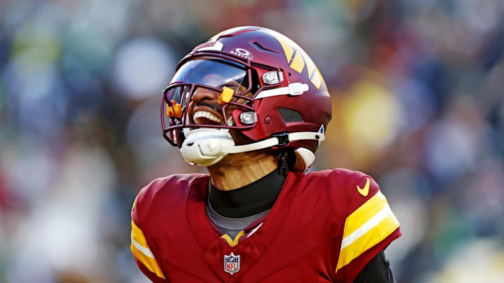 Dec 22, 2024; Landover, Maryland, USA; Washington Commanders quarterback Jayden Daniels (5) celebrates after throwing a touchdown during the fourth quarter against the Philadelphia Eagles at Northwest Stadium. Mandatory Credit: Peter Casey-Imagn Images Dec 22, 2024; Landover, Maryland, USA; Washington Commanders quarterback Jayden Daniels (5) celebrates after throwing a touchdown during the fourth quarter against the Philadelphia Eagles at Northwest Stadium. Mandatory Credit: Peter Casey-Imagn Images
