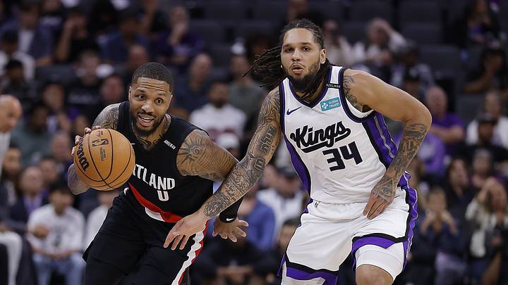 Oct 13, 2026; Sacramento, California, USA; Portland Trail Blazers guard Damian Lillard (0) brings the ball down the court against Sacramento Kings guard Emanuel Sharp (34) during the second quarter at Golden 1 Center. Mandatory Credit: Kelley L Cox-Imagn Images