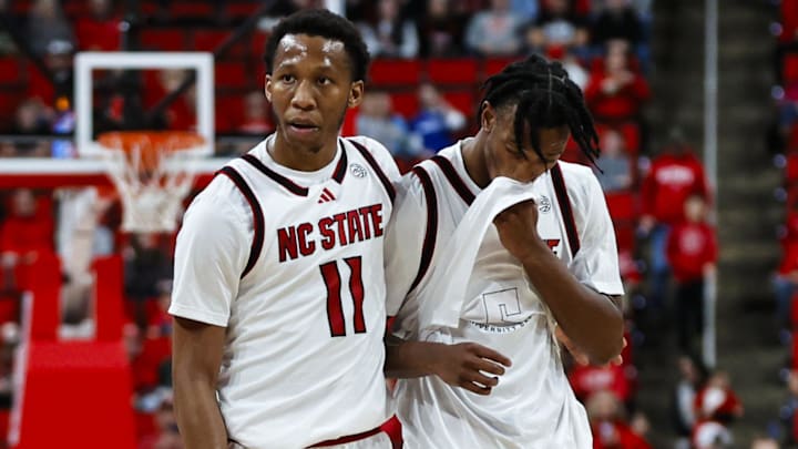 Dec 6, 2025; Raleigh, North Carolina, USA; NC State Wolfpack guard Quadir Copeland (11) consoles guard Jr. Paul McNeil (2) during the second half of the game against UNC Asheville Bulldogs at Lenovo Center. Mandatory Credit: Jaylynn Nash-Imagn Images