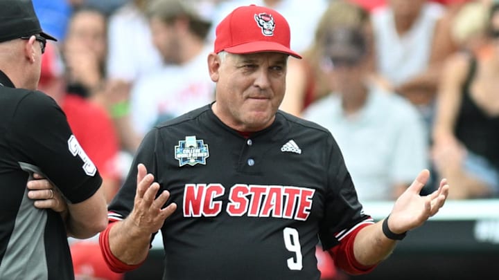 Jun 15, 2024; Omaha, NE, USA;  NC State Wolfpack head coach Elliott Avent discusses a balk call with an umpire in the game against the Kentucky Wildcats during the eighth inning at Charles Schwab Field Omaha. Mandatory Credit: Steven Branscombe-Imagn Images