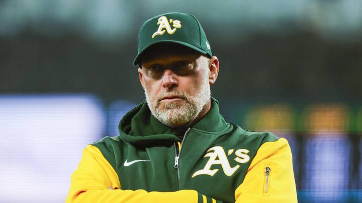 Apr 22, 2026; Seattle, Washington, USA; Athletics manager Mark Kotsay (7) talks with staff in the dugout following a batted ball that was trapped in the jersey of Seattle Mariners starting pitcher Logan Gilbert (36, not pictured) during the first inning at T-Mobile Park. The play was ruled a hit. Mandatory Credit: Joe Nicholson-Imagn Images Apr 22, 2026; Seattle, Washington, USA; Athletics manager Mark Kotsay (7) talks with staff in the dugout following a batted ball that was trapped in the jersey of Seattle Mariners starting pitcher Logan Gilbert (36, not pictured) during the first inning at T-Mobile Park. The play was ruled a hit. Mandatory Credit: Joe Nicholson-Imagn Images