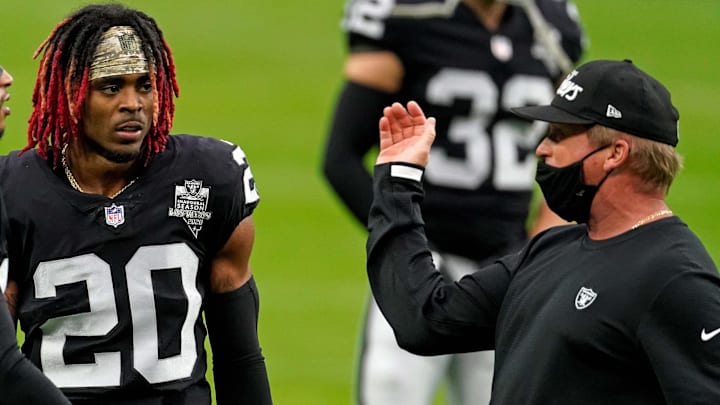 Nov 15, 2020; Paradise, Nevada, USA; Las Vegas Raiders head coach Jon Gruden (right) talks with Las Vegas Raiders strong safety Johnathan Abram (left) and Las Vegas Raiders cornerback Damon Arnette (center) before a game aDenver Broncos at Allegiant Stadium. Mandatory Credit: Kirby Lee-Imagn Images