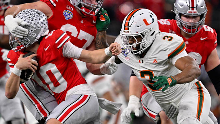 Miami Hurricanes defensive lineman Akheem Mesidor (3) chases Ohio State Buckeyes quarterback Julian Sayin (10) 