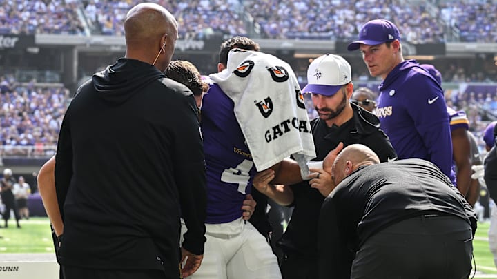 Aug 9, 2025; Minneapolis, Minnesota, USA; Minnesota Vikings wide receiver Rondale Moore (4) is attended to by head coach Kevin O'Connell and trainers after suffering a lower leg injury during the second quarter against the Houston Texans at U.S. Bank Stadium. Mandatory Credit: Jeffrey Becker-Imagn Images Aug 9, 2025; Minneapolis, Minnesota, USA; Minnesota Vikings wide receiver Rondale Moore (4) is attended to by head coach Kevin O'Connell and trainers after suffering a lower leg injury during the second quarter against the Houston Texans at U.S. Bank Stadium. Mandatory Credit: Jeffrey Becker-Imagn Images