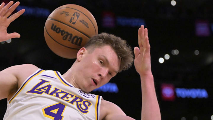Dec 8, 2024; Los Angeles, California, USA;  Los Angeles Lakers guard Dalton Knecht (4) dunks over Portland Trail Blazers forward Toumani Camara (33) in the second half at Crypto.com Arena. Mandatory Credit: Jayne Kamin-Oncea-Imagn Images