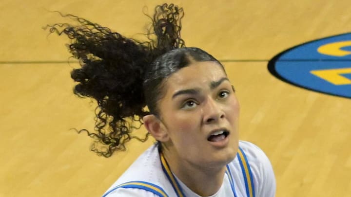UCLA Bruins center Lauren Betts drives past Cal Poly Mustangs forward Gillian Bears.