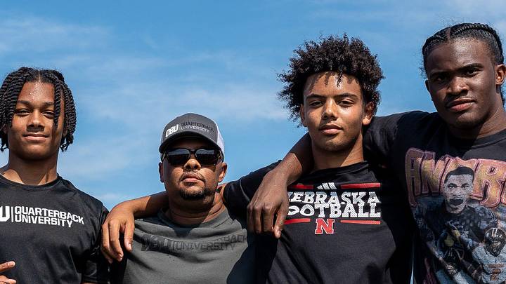 From left to right, Donald Tabron II, 16, Donovan Dooley, 40, owner and founder of Quarterback University, Trae Taylor, 16, and Bryce Underwood, 17, take a photo together after participating in a private workout in Detroit on Saturday, June 21, 2025.