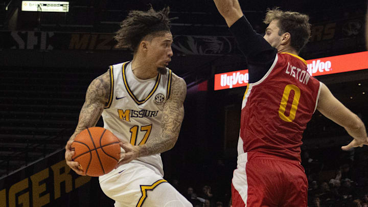 Nov 9, 2025; Columbia, Missouri, USA; Missouri Tigers guard Jayden Stone (17) looks to pass around a defender during a game against the VMI Keydets at Mizzou Arena. 