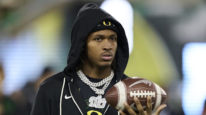Nov 14, 2025; Eugene, Oregon, USA; Oregon Ducks wide receiver Dakorien Moore (1) watches teammates warm up before a game against the Minnesota Golden Gophers at Autzen Stadium. Mandatory Credit: Troy Wayrynen-Imagn Images