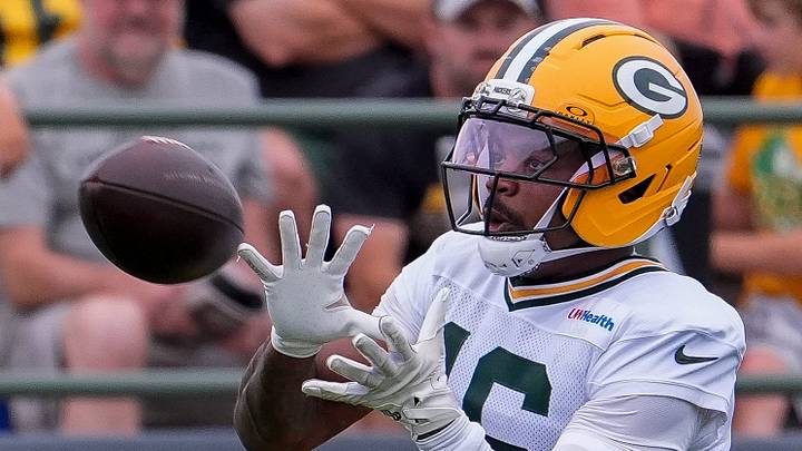 Green Bay Packers receiver Bo Melton (16) catches a pass at training camp. Green Bay Packers receiver Bo Melton (16) catches a pass at training camp.
