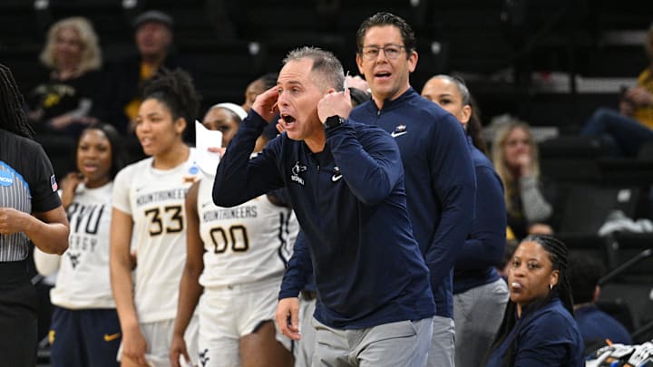 Mar 23, 2024; Iowa City, IA, USA; West Virginia Mountaineers head coach Mark Kellogg (middle) reacts during the second half against the Princeton Tigers of the NCAA first round game at Carver-Hawkeye Arena. Mandatory Credit: Jeffrey Becker-Imagn Images Mar 23, 2024; Iowa City, IA, USA; West Virginia Mountaineers head coach Mark Kellogg (middle) reacts during the second half against the Princeton Tigers of the NCAA first round game at Carver-Hawkeye Arena. Mandatory Credit: Jeffrey Becker-Imagn Images