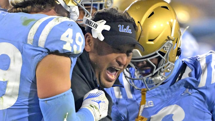 Nov 8, 2024; Pasadena, California, USA; UCLA Bruins defensive coordinator Ikaika Malloe, center, celebrates with linebacker Carson Schwesinger (49) defensive back Jaylin Davies (6) after an interception in the second half against the Iowa Hawkeyes at the Rose Bowl. Mandatory Credit: Jayne Kamin-Oncea-Imagn Images Nov 8, 2024; Pasadena, California, USA; UCLA Bruins defensive coordinator Ikaika Malloe, center, celebrates with linebacker Carson Schwesinger (49) defensive back Jaylin Davies (6) after an interception in the second half against the Iowa Hawkeyes at the Rose Bowl. Mandatory Credit: Jayne Kamin-Oncea-Imagn Images