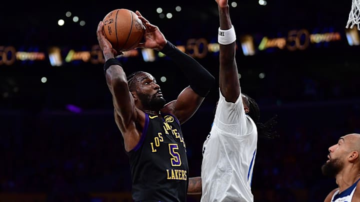 Mar 10, 2026; Los Angeles, California, USA; Los Angeles Lakers center Deandre Ayton (5) moves to the basket against Minnesota Timberwolves center Naz Reid (11) and center Rudy Gobert (27) during the first half at Crypto.com Arena. Mandatory Credit: Gary A. Vasquez-Imagn Images