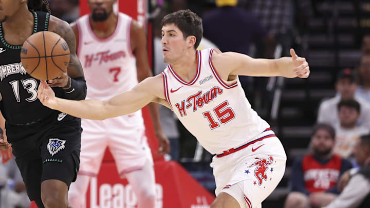 Apr 10, 2026; Houston, Texas, USA; Houston Rockets guard Reed Sheppard (15) attempts to steal the ball away from Minnesota Timberwolves guard Ayo Dosunmu (13) during the third quarter at Toyota Center. Mandatory Credit: Troy Taormina-Imagn Images