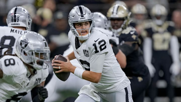Dec 29, 2024; New Orleans, Louisiana, USA; Las Vegas Raiders quarterback Aidan O'Connell (12) falls back during the first half against the New Orleans Saints at Caesars Superdome. Mandatory Credit: Matthew Hinton-Imagn Images Dec 29, 2024; New Orleans, Louisiana, USA; Las Vegas Raiders quarterback Aidan O'Connell (12) falls back during the first half against the New Orleans Saints at Caesars Superdome. Mandatory Credit: Matthew Hinton-Imagn Images