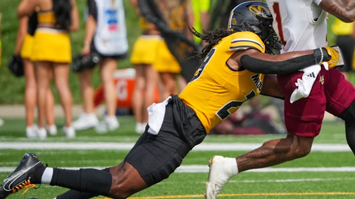 Sep 14, 2024; Columbia, Missouri, USA; Boston College Eagles quarterback Thomas Castellanos (1) runs the ball as Missouri Tigers linebacker Khalil Jacobs (29) makes the tackle during the second half at Faurot Field at Memorial Stadium. Mandatory Credit: Denny Medley-Imagn Images Sep 14, 2024; Columbia, Missouri, USA; Boston College Eagles quarterback Thomas Castellanos (1) runs the ball as Missouri Tigers linebacker Khalil Jacobs (29) makes the tackle during the second half at Faurot Field at Memorial Stadium. Mandatory Credit: Denny Medley-Imagn Images