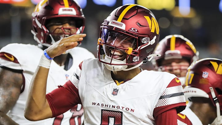 Sep 23, 2024; Cincinnati, Ohio, USA; Washington Commanders quarterback Jayden Daniels (5) reacts after scoring a touchdown against the Cincinnati Bengals in the first half at Paycor Stadium. Mandatory Credit: Katie Stratman-Imagn Images