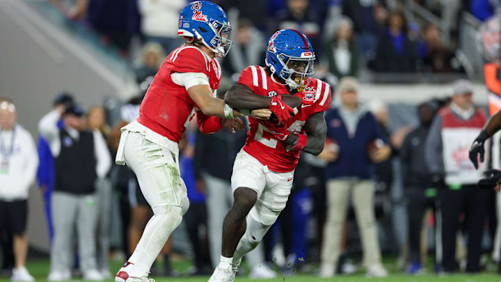 Jan 2, 2025; Jacksonville, FL, USA; Mississippi Rebels quarterback Jaxson Dart (2) hands off to running back Ulysses Bentley IV (24) against the Duke Blue Devils in the second quarter  during the Gator Bowl at EverBank Stadium. Mandatory Credit: Nathan Ray Seebeck-Imagn Images