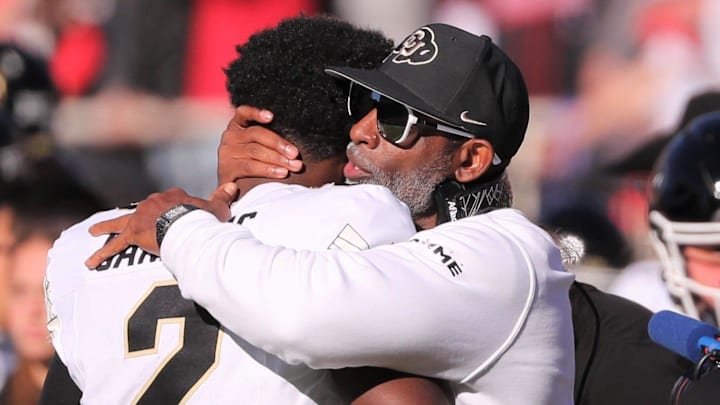 Colorado football coach Deion Sanders hugs his son, Shedeur Sanders, before facing Texas Tech in a Big 12 football game Saturday, Nov. 9, 2024, at Jones AT&T Stadium.