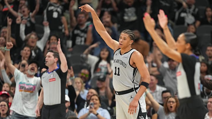 Apr 8, 2026; San Antonio, Texas, USA; San Antonio Spurs forward Carter Bryant (11) and fans react after scoring a 3-point basket during the second half against the Portland Trail Blazers at Frost Bank Center. Apr 8, 2026; San Antonio, Texas, USA; San Antonio Spurs forward Carter Bryant (11) and fans react after scoring a 3-point basket during the second half against the Portland Trail Blazers at Frost Bank Center.