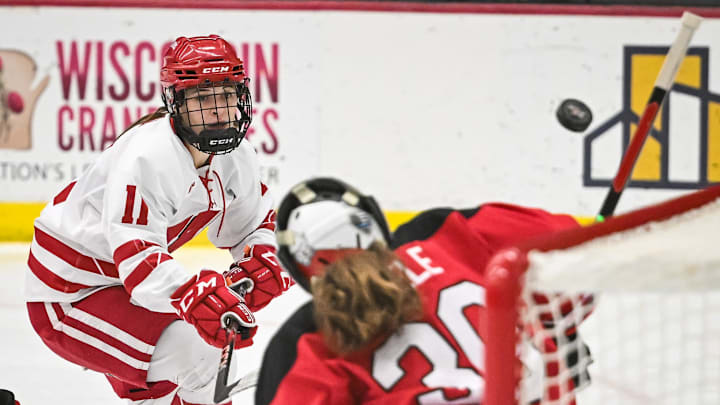 Wisconsin Badgers forward Cassie Hall (11) fires a shot deflected over the net by Ohio State Buckeyes goaltender Amanda Thiele (30) during the first period in a game Thursday, January 2, 2025, at LaBahn Arena in Madison, Wisconsin. Wisconsin Badgers forward Cassie Hall (11) fires a shot deflected over the net by Ohio State Buckeyes goaltender Amanda Thiele (30) during the first period in a game Thursday, January 2, 2025, at LaBahn Arena in Madison, Wisconsin.