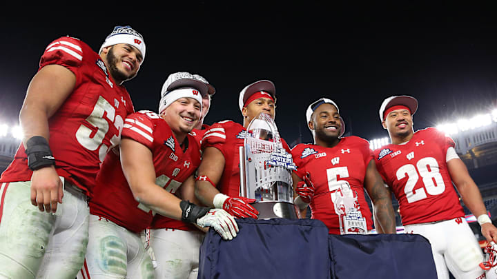 Dec 27, 2018; Bronx, NY, USA; Wisconsin Badgers linebacker T.J. Edwards (53) and fullback Alec Ingold (45) and running back Taiwan Deal (28) and running back Chris James (5) and running back Jonathan Taylor (23) pose for a photo with the trophy after the 2018 Pinstripe Bowl against the Miami Hurricanes at Yankee Stadium. Mandatory Credit: Vincent Carchietta-Imagn Images