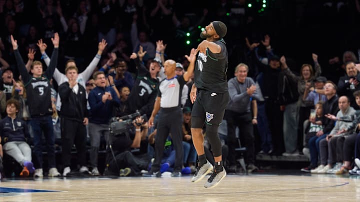 Apr 25, 2026; Minneapolis, Minnesota, USA; Minnesota Timberwolves guard Mike Conley (10) celebrates with fans as he makes a three-point shot against the Denver Nuggets in the fourth quarter at Target Center.