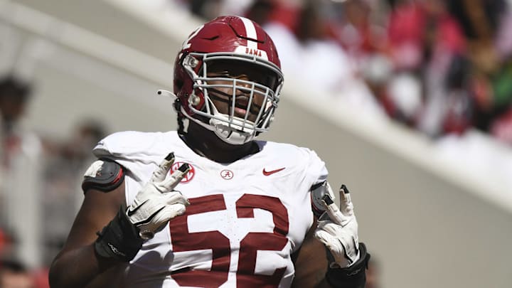 Alabama offensive lineman Tyler Booker (52) celebrates after the offense scored a touchdown Alabama offensive lineman Tyler Booker (52) celebrates after the offense scored a touchdown