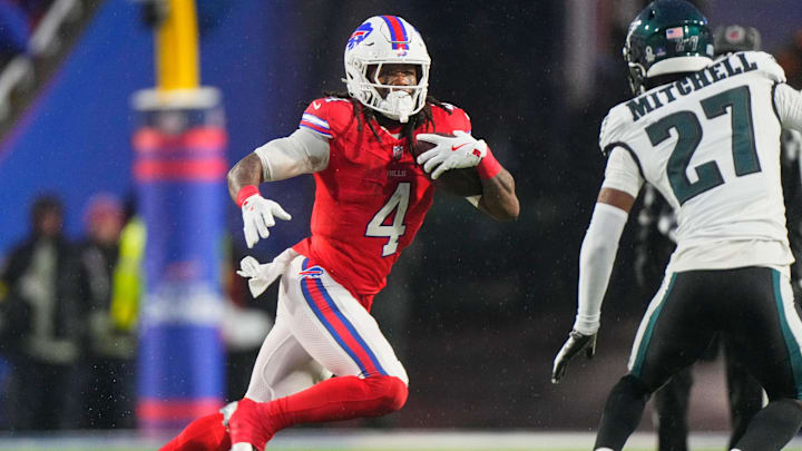 Dec 28, 2025; Orchard Park, New York, USA; Buffalo Bills running back James Cook III (4) runs the ball against Philadelphia Eagles cornerback Quinyon Mitchell (27) during the first quarter at Highmark Stadium. Dec 28, 2025; Orchard Park, New York, USA; Buffalo Bills running back James Cook III (4) runs the ball against Philadelphia Eagles cornerback Quinyon Mitchell (27) during the first quarter at Highmark Stadium.