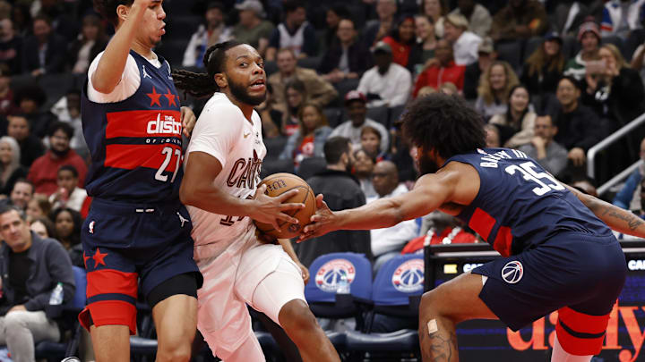 Nov 7, 2025; Washington, District of Columbia, USA; Cleveland Cavaliers guard Darius Garland (10) drives to the basket as Washington Wizards guard Will Riley (27).and Wizards forward Marvin Bagley III (35) defend in the second half in an Emirates NBA Cup game at Capital One Arena. Mandatory Credit: Geoff Burke-Imagn Images