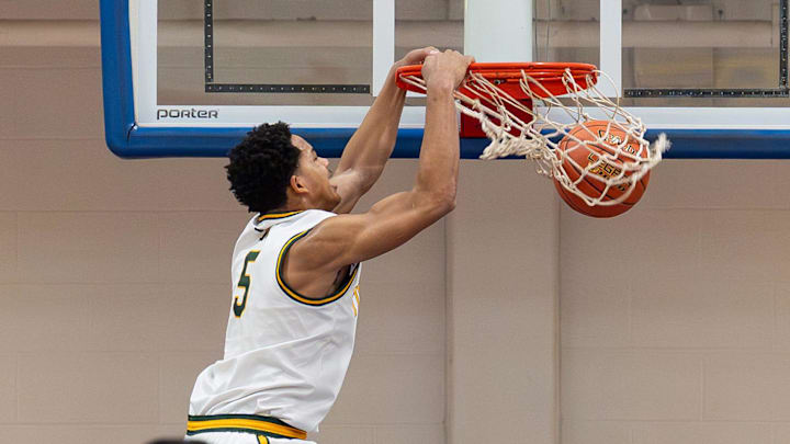 St. Xavier's Joshua Lindsay (5) dunks the ball during first half action as the St. Xavier Tigers battle the Ballard Bruins in the KHSAA 7th Region boys basketball final at Valley High School on March 9, 2026, in Louisville, Ky.