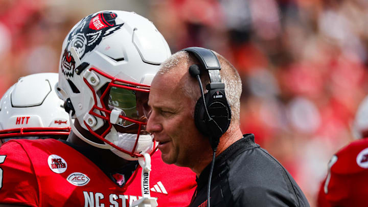 Sep 14, 2024; Raleigh, North Carolina, USA;  North Carolina State Wolfpack tight end Justin Joly (15) and head coach Dave Doeren talk during the second half of the game against Louisiana Tech Bulldogs at Carter-Finley Stadium. Mandatory Credit: Jaylynn Nash-Imagn Images