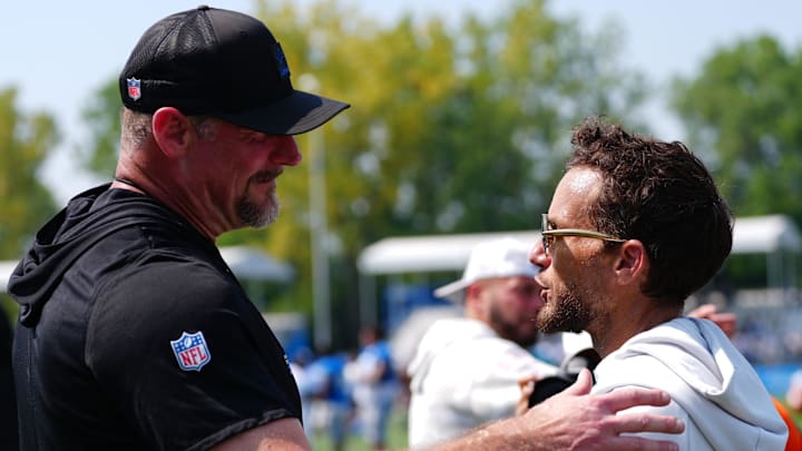 Detroit Lions coach Dan Campbell shakes hands with Miami Dolphins coach Mike McDaniels after joint practice 