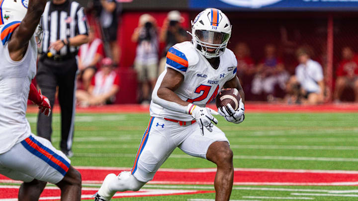 Sep 13, 2025; Lincoln, Nebraska, USA; Houston Christian Huskies running back Xai'Shaun Edwards (24) runs for a touchdown against Nebraska Cornhuskers defensive back Jeremiah Charles (25) during the third quarter at Memorial Stadium. Mandatory Credit: Dylan Widger-Imagn Images