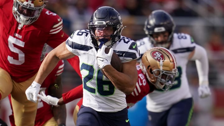 Dec 10, 2023; Santa Clara, California, USA; Seattle Seahawks running back Zach Charbonnet (26) runs past San Francisco 49ers linebacker Randy Gregory (5) in the first quarter at Levi's Stadium. Mandatory Credit: Cary Edmondson-USA TODAY Sports