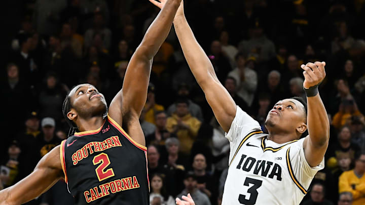 Jan 28, 2026; Iowa City, Iowa, USA; Southern California Trojans forward Ezra Ausar (2) and Iowa Hawkeyes forward Cam Manyawu (3) battle for the opening tipoff during the first half at Carver-Hawkeye Arena. Mandatory Credit: Jeffrey Becker-Imagn Images