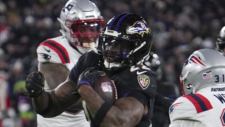 Baltimore Ravens running back Derrick Henry runs the ball against New England Patriots safety Craig Woodson.