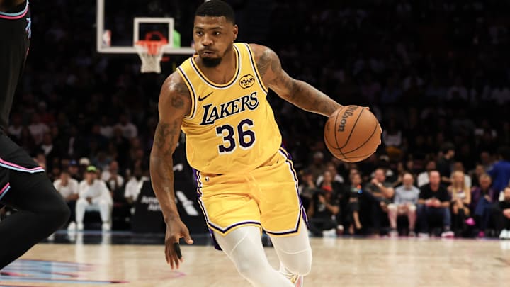 Mar 19, 2026; Miami, Florida, USA; Los Angeles Lakers guard Marcus Smart (36) drives to basket against Miami Heat center Bam Adebayo (13) during first half at Kaseya Center. Mandatory Credit: Isabella Frias-Imagn Images