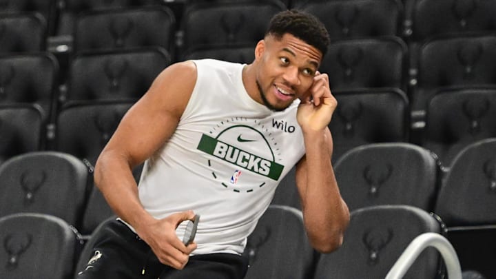 Nov 1, 2025; Milwaukee, Wisconsin, USA;  Milwaukee Bucks forward Giannis Antetokounmpo (34) sits on the scorers table during warmups before game against the Sacramento Kings at Fiserv Forum. Mandatory Credit: Benny Sieu-Imagn Images