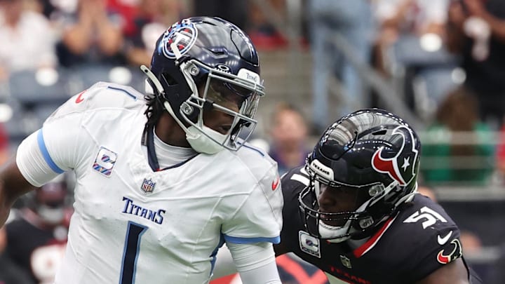 Tennessee Titans quarterback Cam Ward scrambles from Houston Texans defensive end Will Anderson Jr.