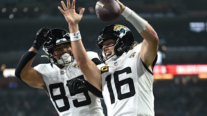 Dec 28, 2025; Indianapolis, Indiana, USA; Jacksonville Jaguars quarterback Trevor Lawrence (16) celebrates with tight end Brenton Strange (85) after a touchdown against the Indianapolis Colts during the first half at Lucas Oil Stadium. Mandatory Credit: Robert Goddin-Imagn Images