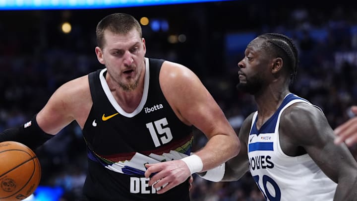 Dec 25, 2025; Denver, Colorado, USA; Minnesota Timberwolves forward Julius Randle (30) defends on Denver Nuggets center Nikola Jokic (15) at Ball Arena.