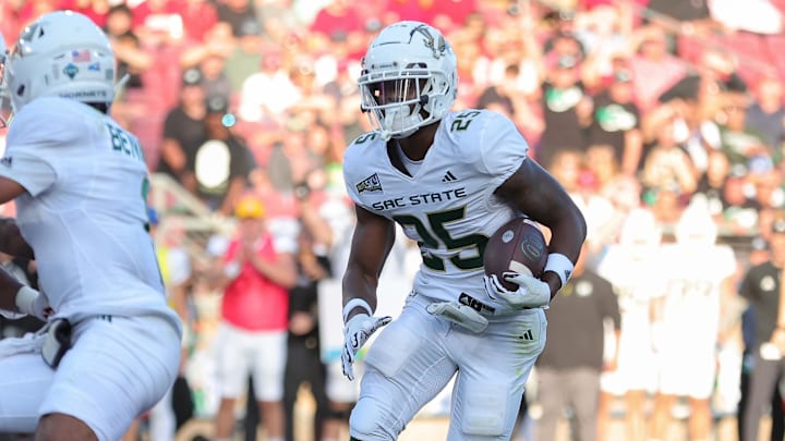 Sep 16, 2023; Stanford, California, USA; Sacramento State Hornets running back Elijah Tau-Tolliver (25) scores a touchdown during the second quarter against the Stanford Cardinal at Stanford Stadium. Mandatory Credit: Sergio Estrada-Imagn Images Sep 16, 2023; Stanford, California, USA; Sacramento State Hornets running back Elijah Tau-Tolliver (25) scores a touchdown during the second quarter against the Stanford Cardinal at Stanford Stadium. Mandatory Credit: Sergio Estrada-Imagn Images