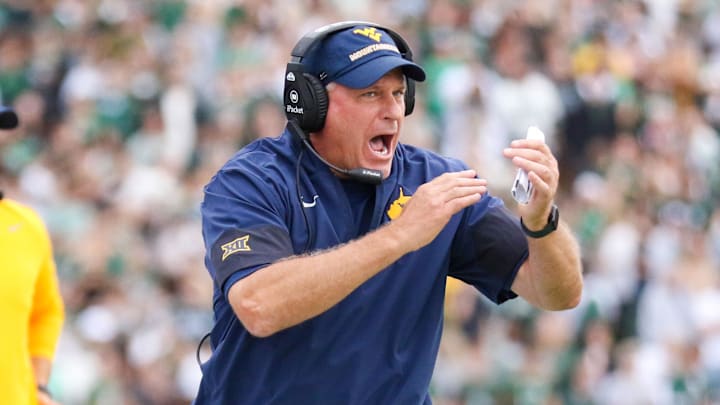 Sep 6, 2025; Athens, Ohio, USA; West Virginia Mountaineers head coach Rich Rodriguez calls a timeout during the second quarter against the Ohio Bobcats at Peden Stadium. Mandatory Credit: Ben Queen-Imagn Images