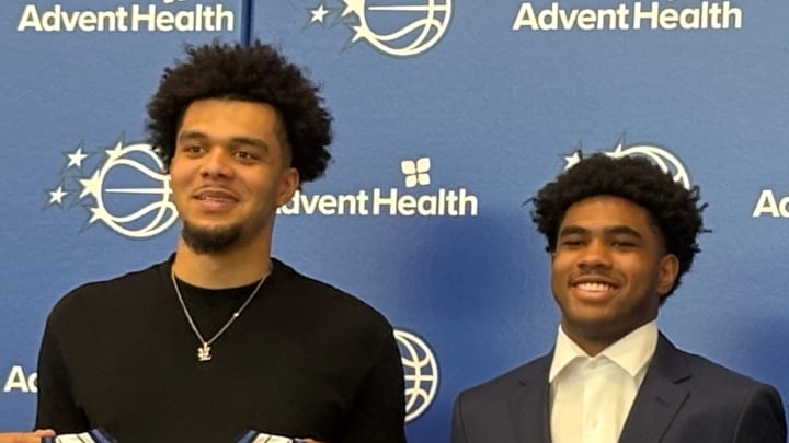 Jase Richardson and Noah Penda pose with Orlando Magic president of basketball operations Jeff Weltman and head coach Jamahl Mosley at an introductory Press Conference. 